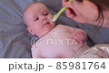 Caucasian mother giving liquid medicine to her baby. Healthcare and child treatment concept. 85981764