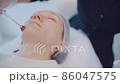Close up of cosmetologist hands put moisturizer butter on girl face by brush. Skin care concept  86047575