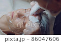 The cosmetologist cleanses the face of acne with his hands. Professional skin care. Skin cleaning  86047606
