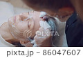 The cosmetologist cleanses the face of acne with his hands. Professional skin care. Facial cleaning  86047607