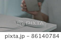 Men's hand putting the smartphone on the white wireless charger 86140784