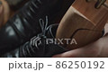 A man who inserts a shoe keeper's last into his shoes to do shoe care for black business shoes 86250192