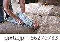 father swaddles a newborn son in a blue diaper 86279733