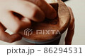 Open the wooden lid and scoop coffee powder from a glass container with a special spoon. Men's hands 86294531
