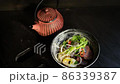 asian food on a black table.Ramen soup on a dark background. vertical video 86339387
