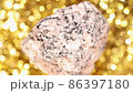 granite stone on a golden background. Close up. 86397180