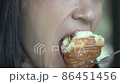 Asian Woman Eating Croissant For Breakfast. Close up asia female of eating bakery at cafe. 86451456