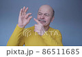 Senior sad caucasian man gesturing with hand doing small size sign with fingers 86511685