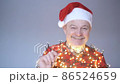 Senior man in red christmas hat dancing celebrating New Year. 86524659