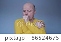 Senior hispanic man coughing because of pulmonary disease 86524675