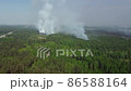 Large smoke clouds and fire spread. Aerial view of smoking wild fire 86588164