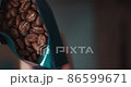 A man refilling coffee opened from a bag into a glass container 86599671