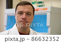 Doctor standing in vintage-style laboratory and turning his head in disagreement 86632352