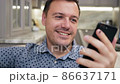 Guy greeting and talking by video conference via mobile application. Smiling male meeting family 86637171