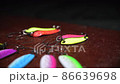 Spinners of different colors and shapes for fishing on a brown table. Background in blur. 86639698