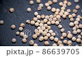 Close-up video of a slowly rotating white pepper on a gray wooden table. Background in blur. 86639705