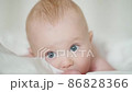 Cute baby lying on bed 86828366