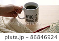 Image of hot coffee and knitting in a mug 86846924