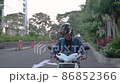Asian man riding a motorcycle on the street 86852366