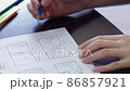 Hands type text on laptop keyboard, part of the screen is visible, slow-motion video 86857921