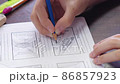 Hands type text on laptop keyboard, part of the screen is visible, slow-motion video 86857923