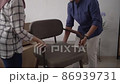 muslim young couple moving new chair at their new home 86939731