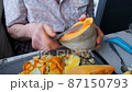 Old woman cuts and pills yellow pumpkin, cooking pumpkin soup, retirement life, selective focus 87150793