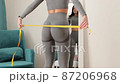 slim Woman waist Measuring With Tape at home 87206968