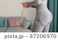 happy Woman Measuring body With Tape after weight loss fitness workout 87206970