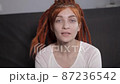 portrait of a red-haired girl who looks into the camera and says 87236542