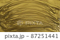 Abstract motion of striped oily gold paint. Gold liquid paints moving and mixing. Compression and flows of paint 87251441