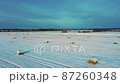 Aerial view of pile of haystacks in winter season. 87260348