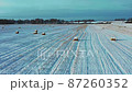 Aerial view of pile of haystacks in winter season. 87260352