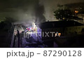 Burning residential building firefighter truck rescue team night  87290128