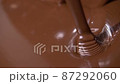 Close-up stirring chocolate, hot melted liquid chocolate. 87292060