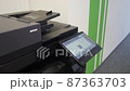 Young man copies documents on a copying system in office 87363703