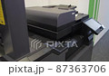 Young man copies documents on a copying system in office 87363706
