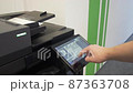 Young man copies documents on a copying system in office 87363708
