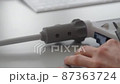 Engineer takes measurements with a caliper gauge. 87363724