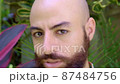 a portrait of a bearded gay man against tropical background 87484756
