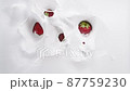 Top view of big red strawberries falling down to the milk with messy splashes 87759230
