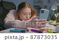 Tired female designer using mobile phone 87873035