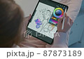 Female designer draws a sketch on a tablet pc 87873189