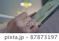 Female designer draws a sketch on a tablet pc 87873197