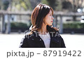 Woman walking in the park 87919422