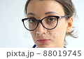 Female doctor is putting off protective blue gloves isolated on white background after some medical manipulations, vaccination. 88019745
