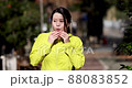 A woman who takes off her mask and breathes while exercising 88083852
