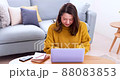 Woman operating a personal computer 88083853