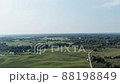 Aerial panorama of rural road passing through agricultural land and pasture fields in Latvia 88198849