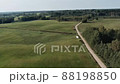 Aerial panorama of rural road passing through agricultural land and pasture fields in Latvia 88198850
